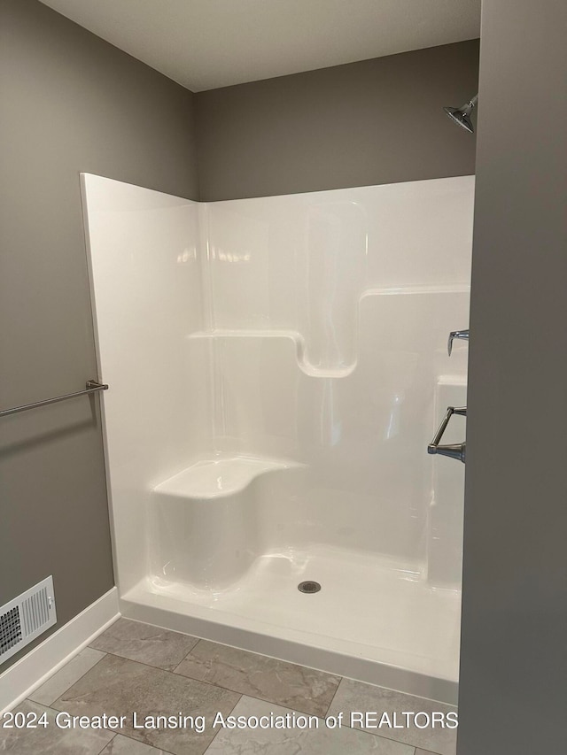 bathroom featuring tile floors and walk in shower