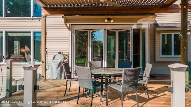 view of patio / terrace featuring a deck and outdoor dining space