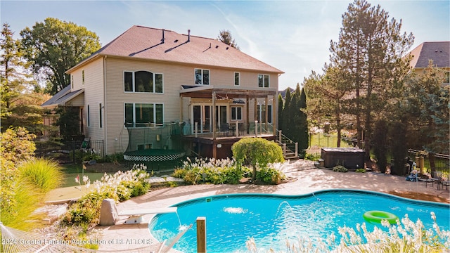 outdoor pool featuring a hot tub, a pergola, and a patio