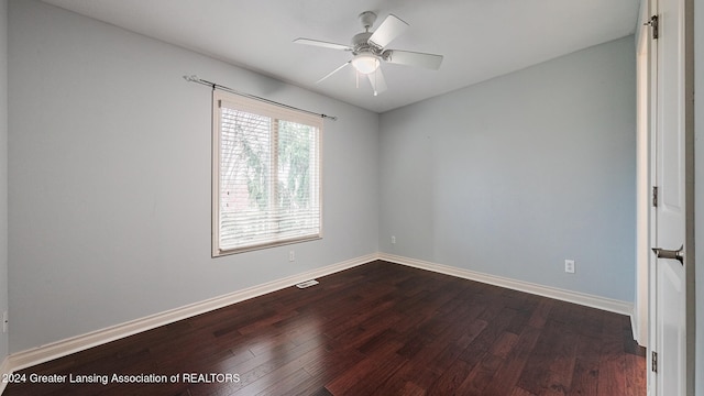 spare room with ceiling fan, wood finished floors, visible vents, and baseboards