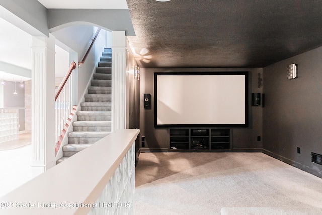 cinema room with carpet, decorative columns, and baseboards