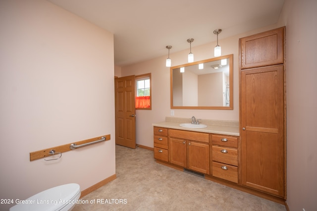 bathroom featuring vanity and toilet