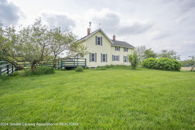 back of house with a lawn