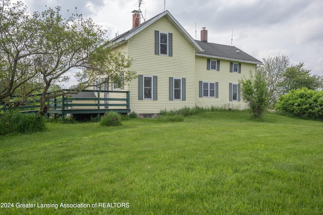 back of property featuring a yard