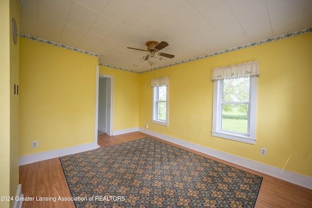 spare room featuring wood-type flooring and ceiling fan