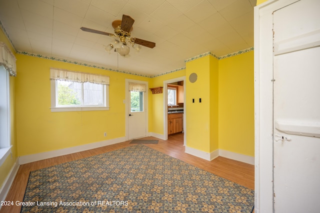 unfurnished room with hardwood / wood-style floors and ceiling fan