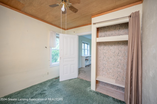 carpeted empty room featuring ceiling fan and wooden ceiling