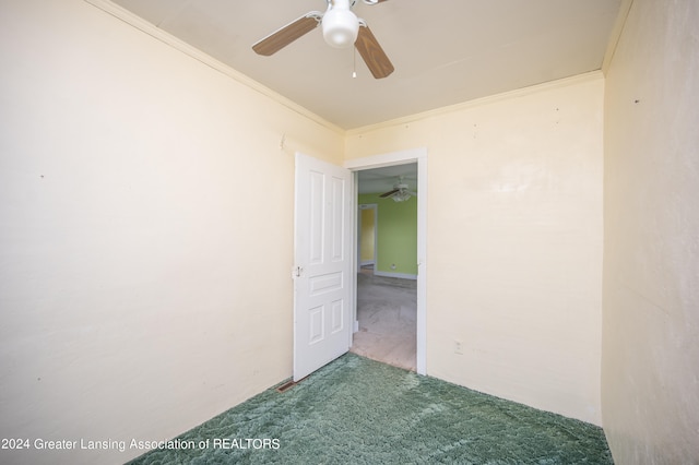 spare room with crown molding and carpet