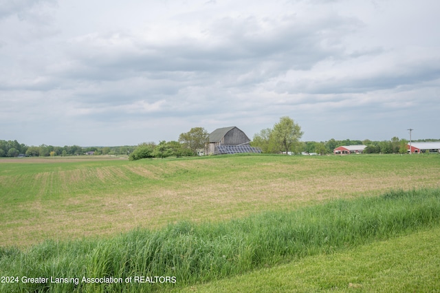 view of yard featuring an outbuilding and a rural view