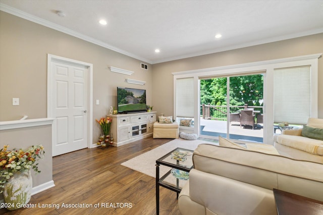 living room featuring dark hardwood / wood-style floors and ornamental molding