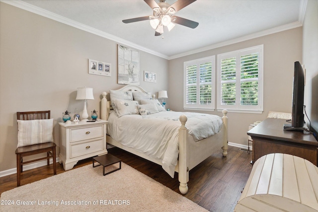 bedroom with dark hardwood / wood-style flooring, ceiling fan, and crown molding