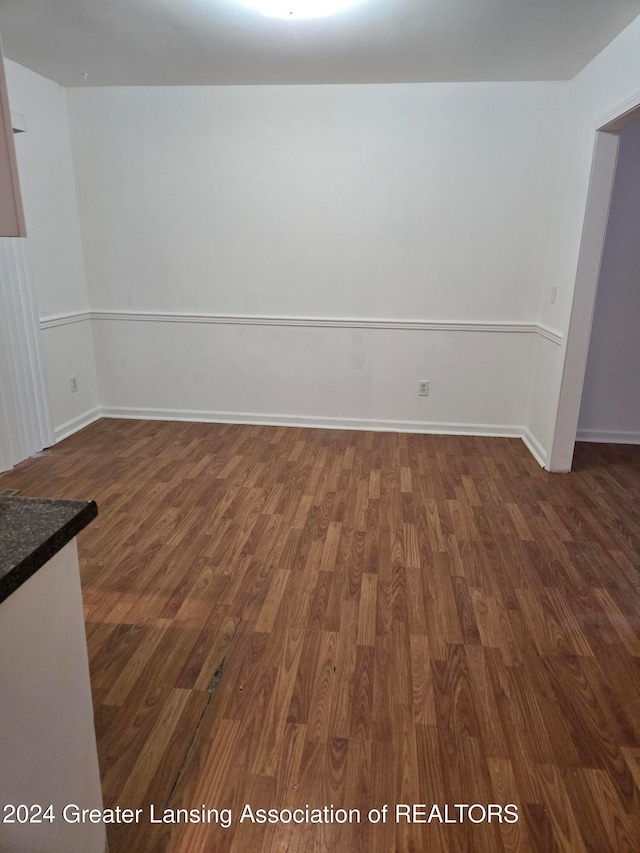 empty room featuring dark wood-type flooring