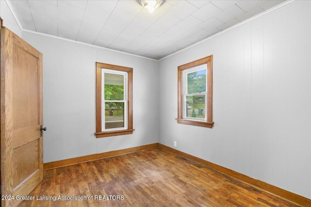 spare room with dark hardwood / wood-style flooring and ornamental molding