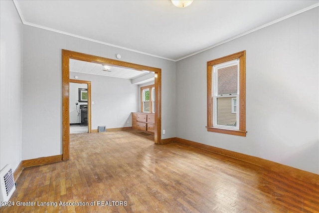 unfurnished room with crown molding and hardwood / wood-style floors