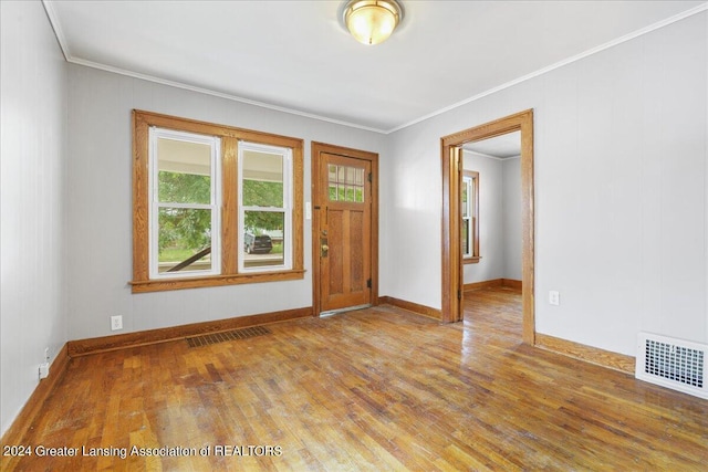 foyer entrance with hardwood / wood-style floors and ornamental molding