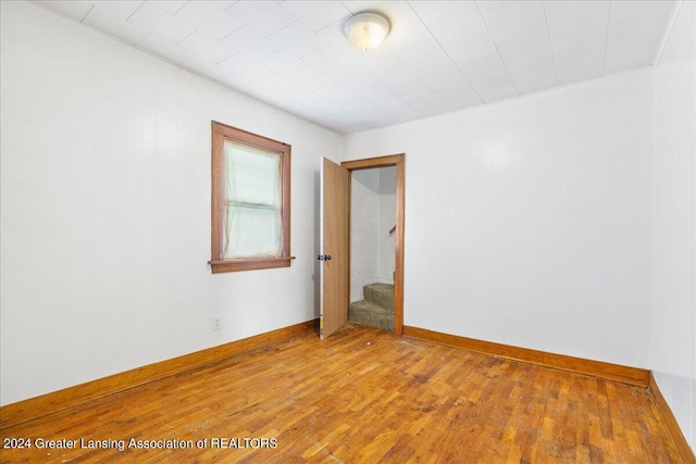 unfurnished room with hardwood / wood-style floors