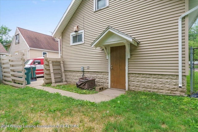 property entrance with a yard