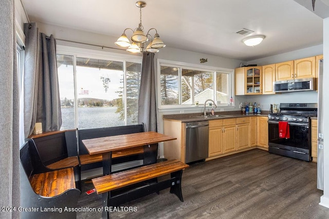 411 N Scott Dr, Farwell, MI 48622 - kitchen with appliances with stainless steel finishes, light brown cabinetry, a chandelier, and glass insert cabinets