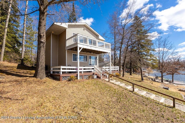 411 N Scott Dr, Farwell, MI 48622 - back of property featuring a deck with water view and a lawn