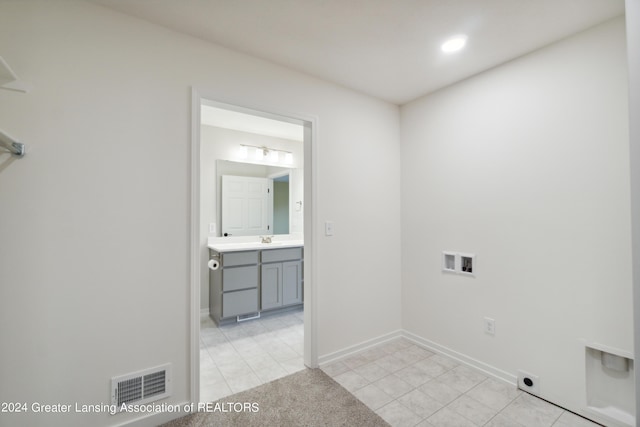 laundry area featuring washer hookup, light tile patterned floors, and electric dryer hookup