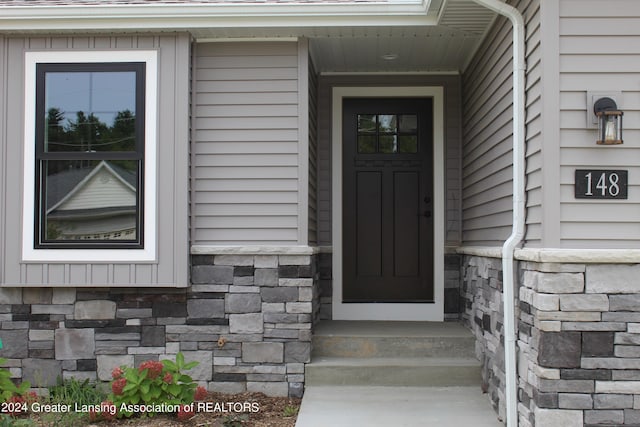 302 Vansickle Dr Unit 35, Charlotte, MI 48813 - entrance to property with stone siding