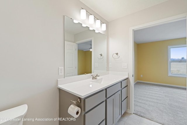 302 Vansickle Dr Unit 35, Charlotte, MI 48813 - half bath with tile patterned flooring, vanity, baseboards, toilet, and a ceiling fan
