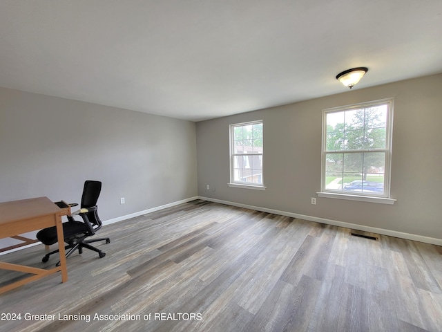 unfurnished office with hardwood / wood-style flooring