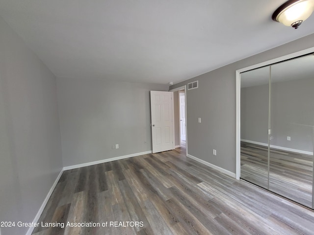 spare room with wood-type flooring