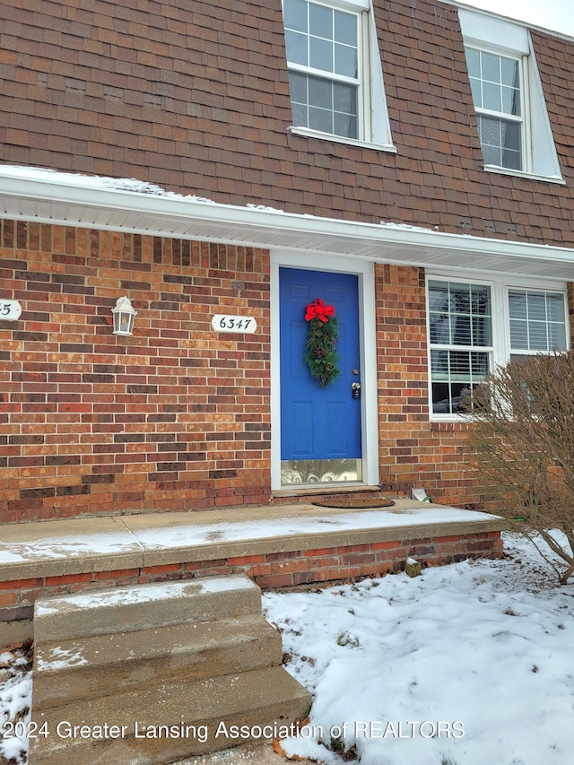 view of snow covered property entrance