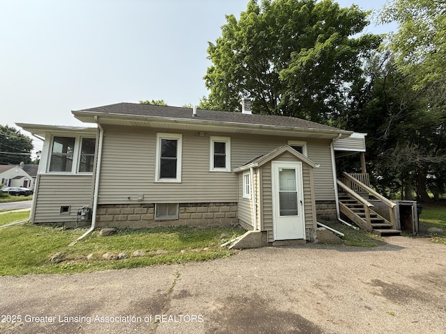 1555 Roosevelt Ave, Lansing, MI 48915 - rear view of property featuring a chimney and stairway