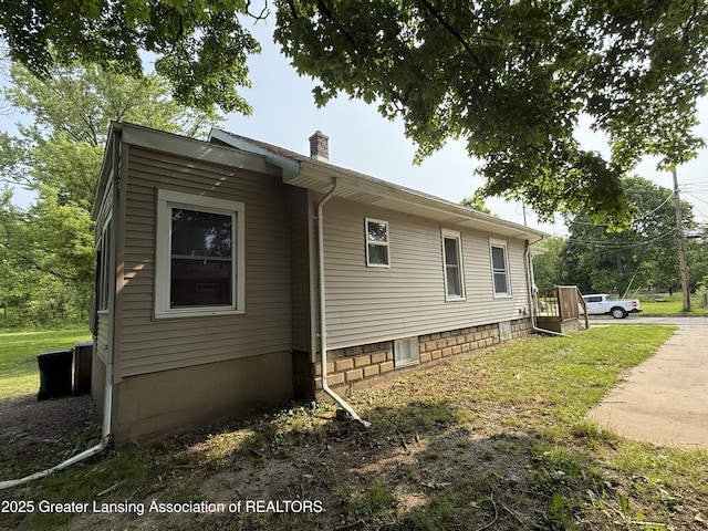 1555 Roosevelt Ave, Lansing, MI 48915 - view of property exterior featuring a chimney and a lawn