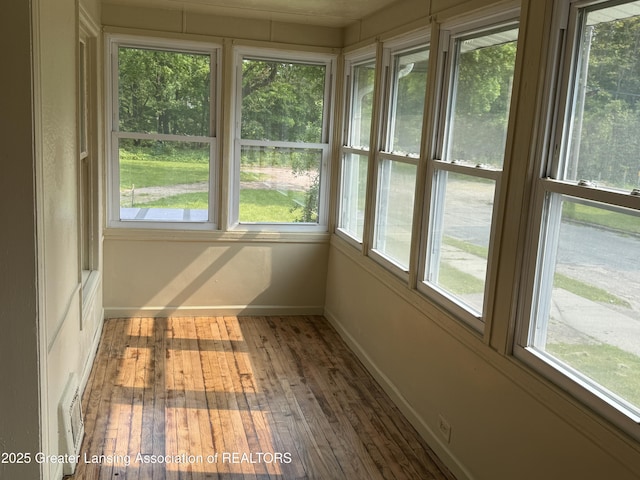 1555 Roosevelt Ave, Lansing, MI 48915 - unfurnished sunroom featuring wood-type flooring and baseboards