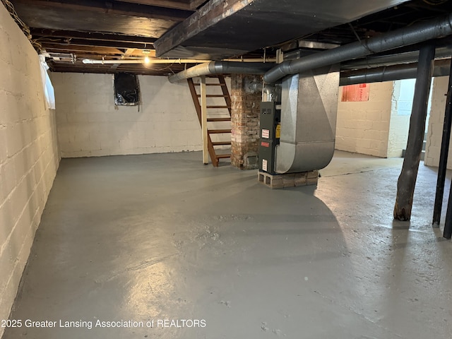 1555 Roosevelt Ave, Lansing, MI 48915 - unfinished below grade area featuring heating unit and stairs