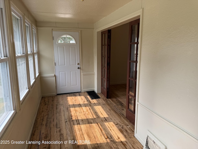 1555 Roosevelt Ave, Lansing, MI 48915 - foyer entrance featuring hardwood / wood-style floors and baseboards