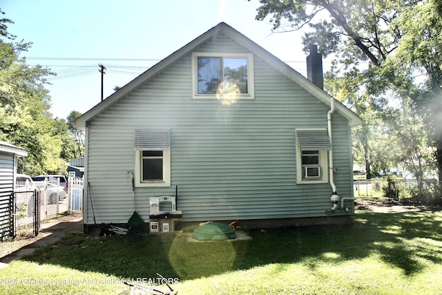 rear view of property with a lawn