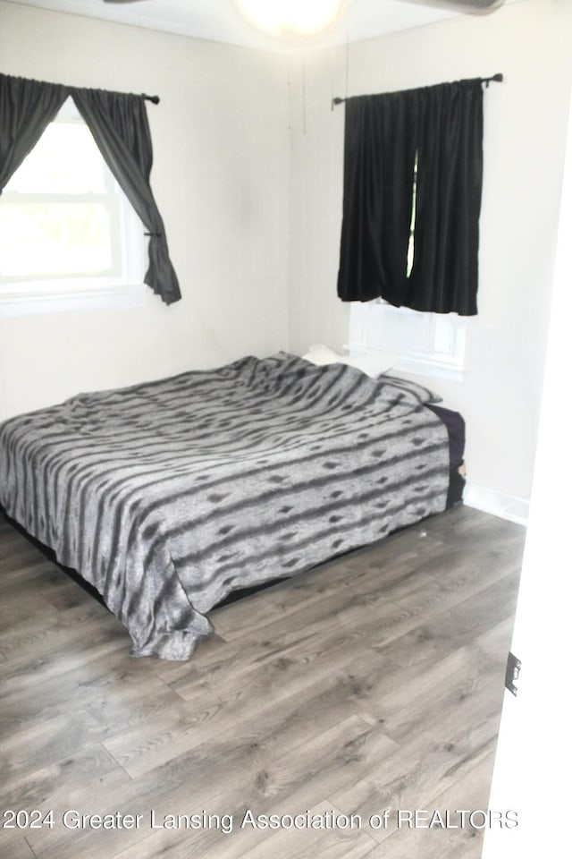 bedroom with wood-type flooring