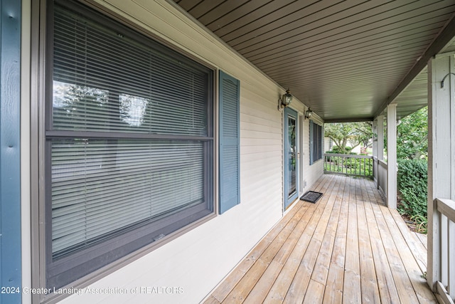 wooden terrace featuring covered porch