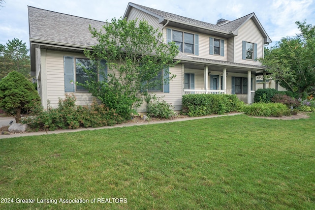 view of front of home featuring a front yard and a porch