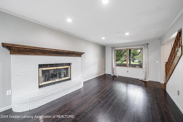 unfurnished living room featuring dark hardwood / wood-style flooring, crown molding, and a fireplace