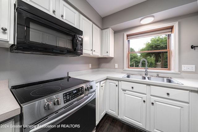 kitchen featuring white cabinetry, sink, electric range, and dark hardwood / wood-style flooring