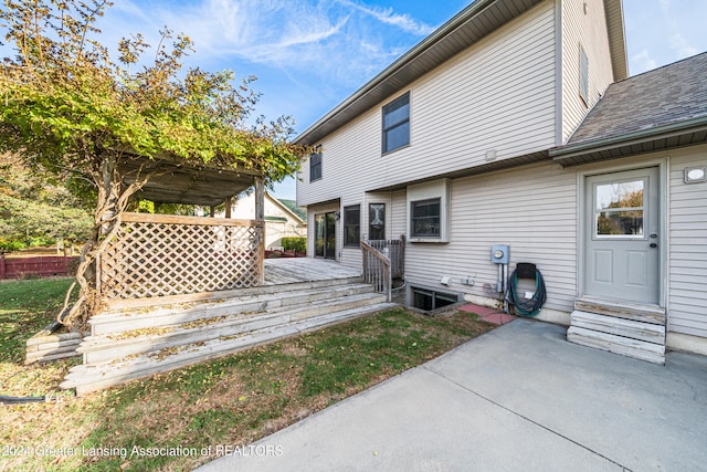 rear view of house featuring a deck and a patio