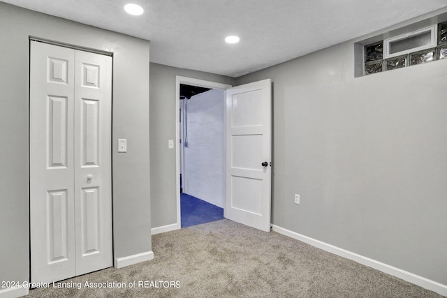 unfurnished bedroom with a closet and carpet flooring