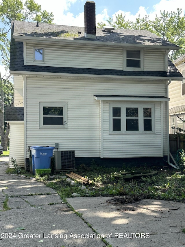 rear view of house featuring central AC unit