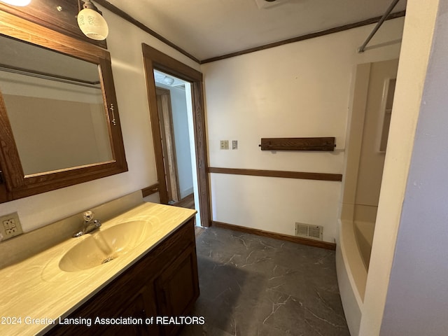 bathroom with bathtub / shower combination, vanity, and ornamental molding