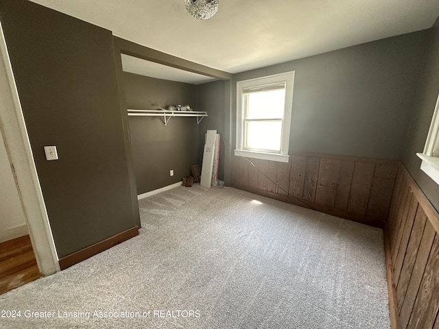 unfurnished bedroom featuring a closet and carpet floors