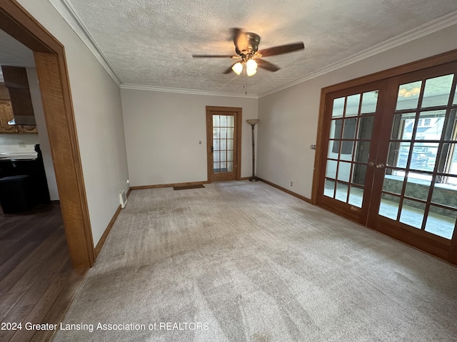 empty room with carpet, french doors, a textured ceiling, and ceiling fan