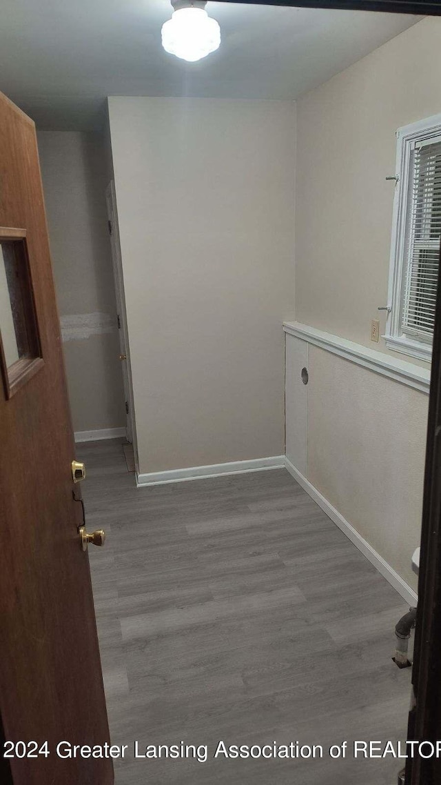 empty room with baseboards and wood finished floors