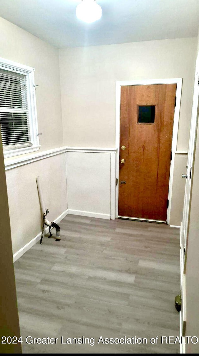 spare room featuring wainscoting and wood finished floors