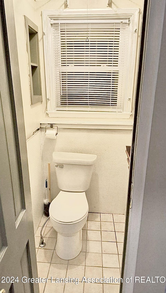 bathroom with tile patterned flooring and toilet