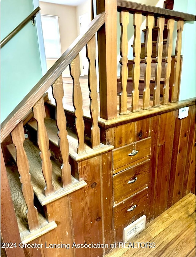 stairs featuring wood finished floors